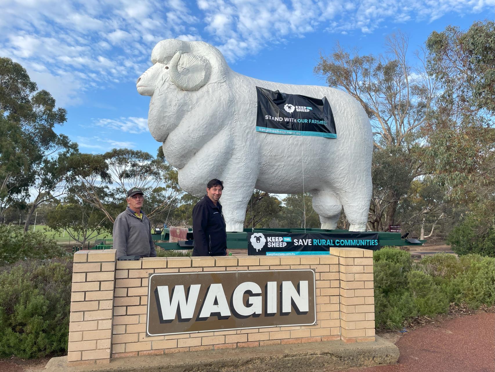 Shire of Wagin: Wagin Shire President Cr Phillip Blight and Cr Wade Longmuir with Wagin’s iconic ram statue ‘Bart’ decorated with the Keep the Sheep Banners.